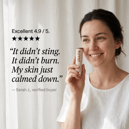 Smiling woman holding the Pluune acne stick to her cheek beside a 4.9 out of 5 review quote, "It didn't sting"
