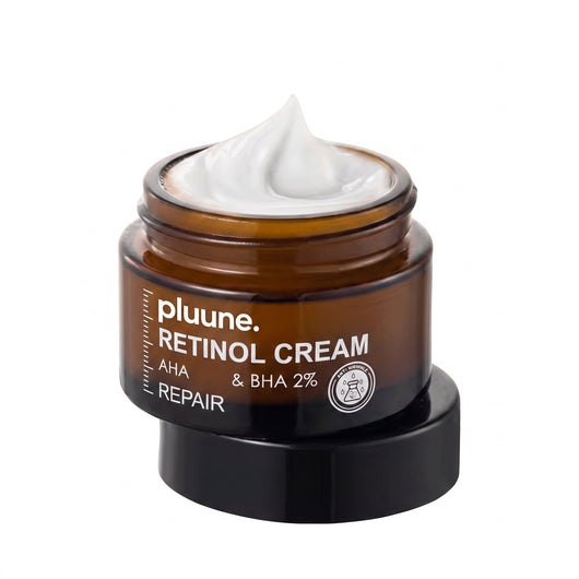 Open amber glass jar of Pluune Retinol Cream filled with white cream, resting on its black lid